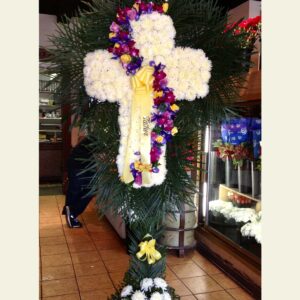 CR1050: White carnation cross with purple swirl and palm leaf